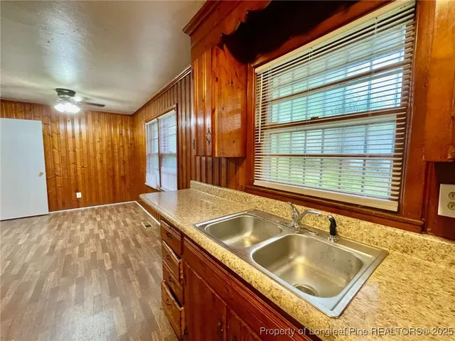 a bathroom with a granite countertop sink and a large mirror