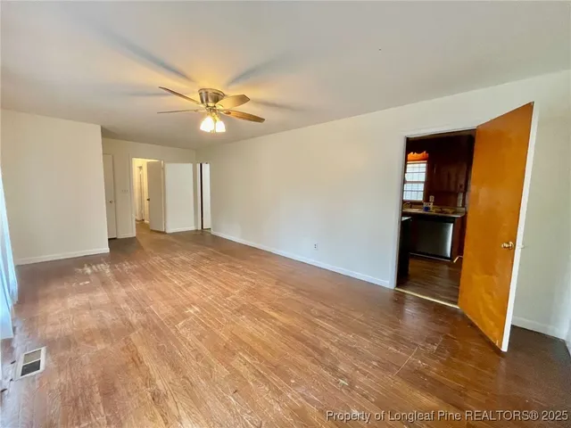 wooden floor in an empty room with a window