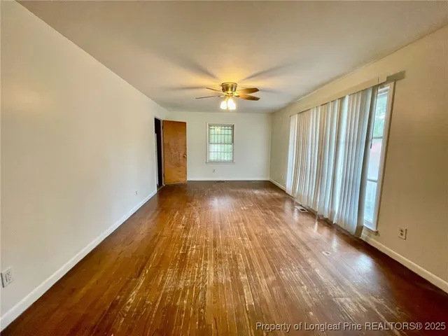 wooden floor in an empty room with a window
