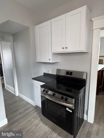 a stove top oven sitting inside of a kitchen