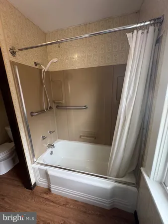 a bathroom with a tub and a shower