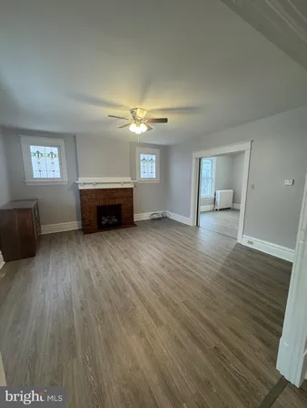 a view of livingroom with hardwood floor and a ceiling fan