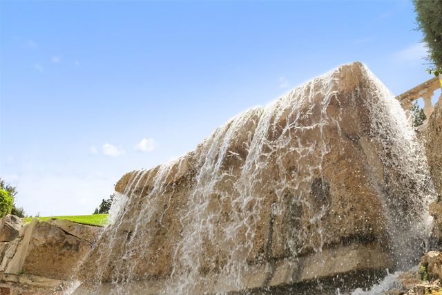 a view of a swimming pool with a yard