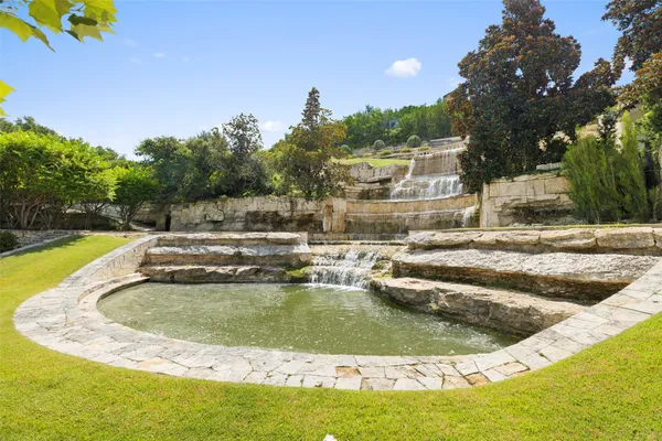 a view of a swimming pool with a yard