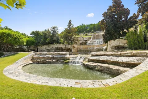 a living room with a bed and a chandelier