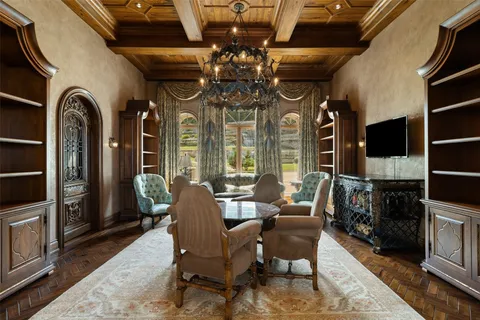 a view of a dining room and kitchen with a chandelier