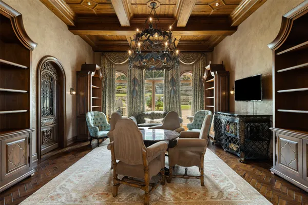 a view of a dining room and kitchen with a chandelier