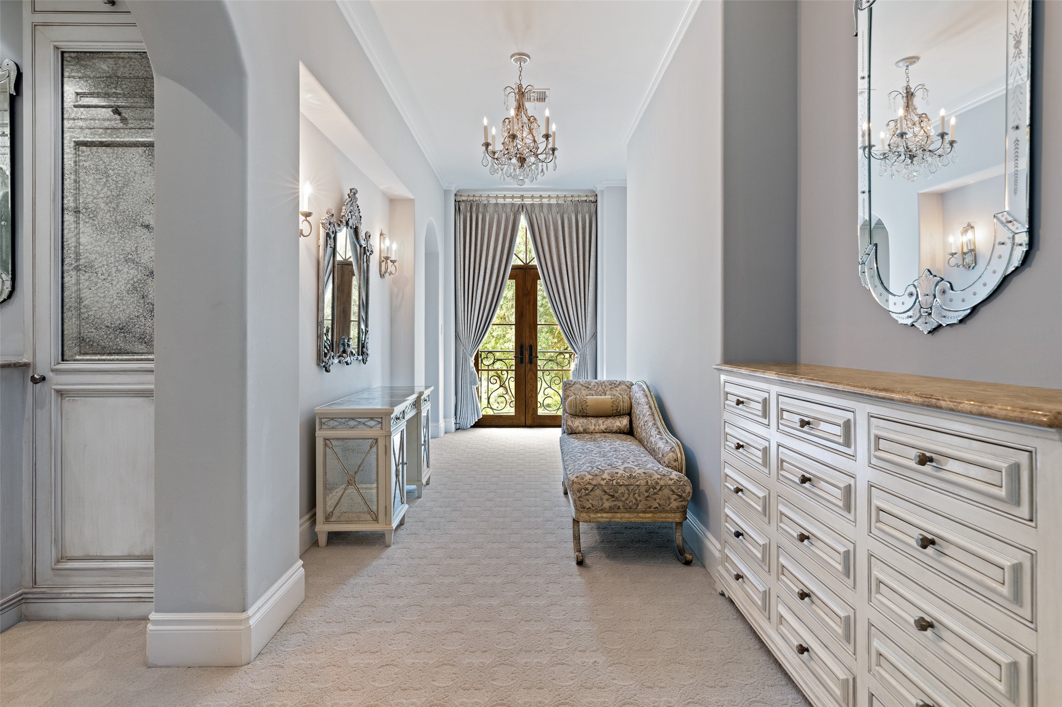 12400 Cedar Street Austin, TX 78732 - Photo 27 of 39 a bedroom with a bed a chandelier and a mirror on the dresser