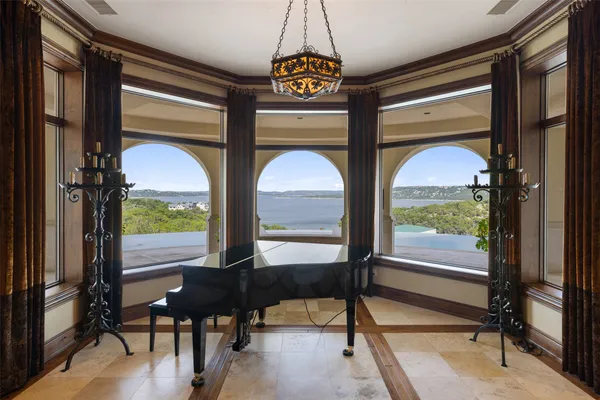a room with furniture pool table and a large window