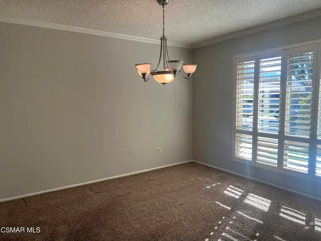 a view of a room with a window and a ceiling fan