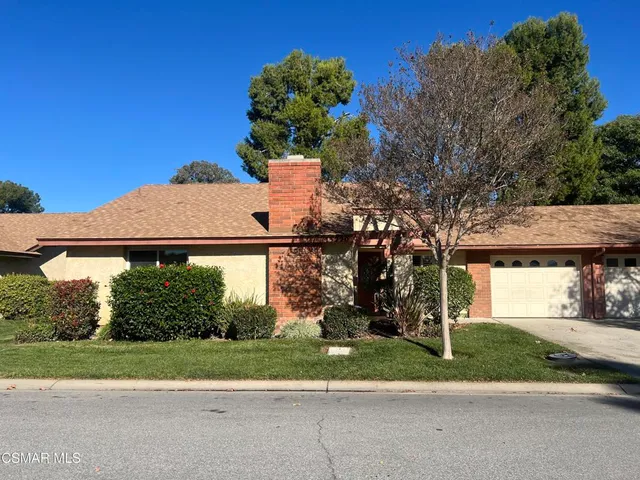 a view of a house with a yard and plants
