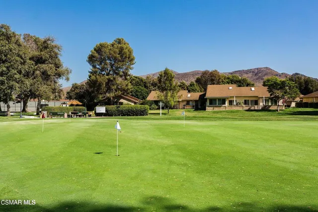 a view of a house with swimming pool and sitting area