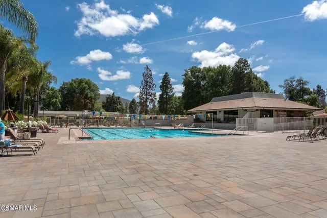 a view of a patio with table and chairs and potted plants
