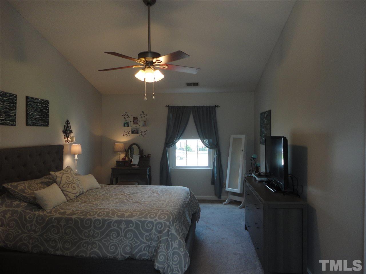 2369 Declaration Drive Raleigh, NC 27615 - Photo 13 of 20 a bedroom with a bed and a chandelier