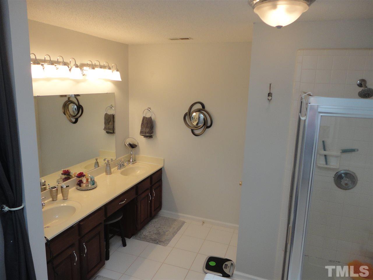 2369 Declaration Drive Raleigh, NC 27615 - Photo 14 of 20 a bathroom with a sink vanity and mirror