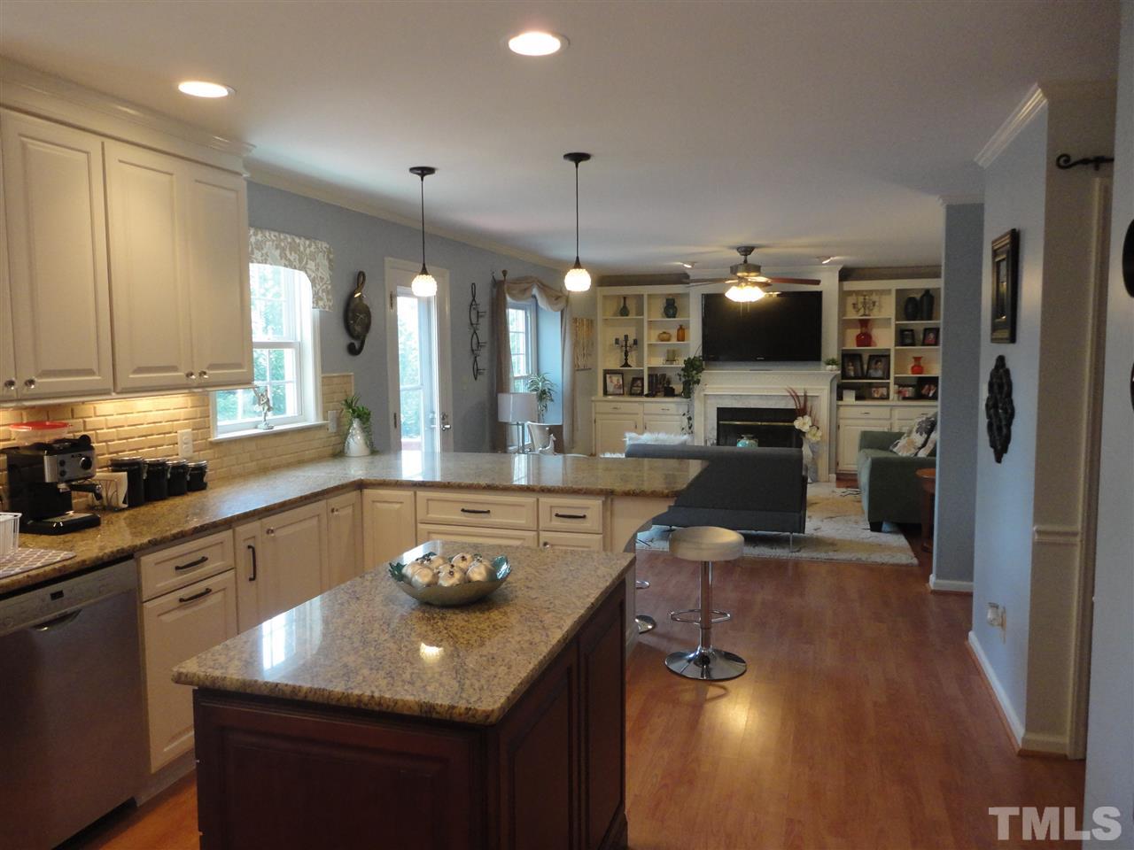 2369 Declaration Drive Raleigh, NC 27615 - Photo 5 of 20 a kitchen with a sink a counter top space a large window and stainless steel appliances