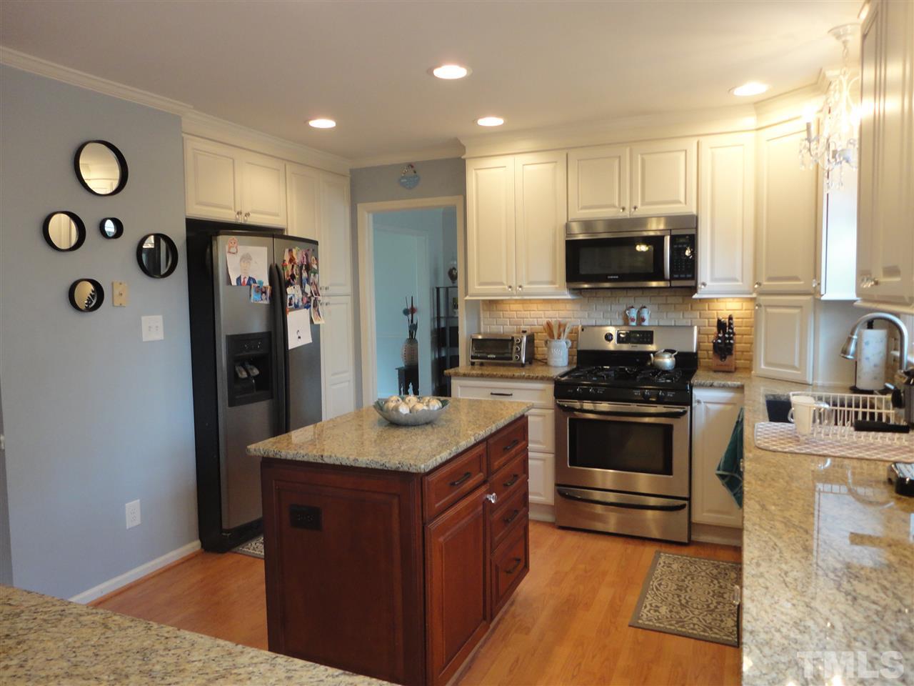 2369 Declaration Drive Raleigh, NC 27615 - Photo 8 of 20 a kitchen with stainless steel appliances granite countertop a stove a sink and a refrigerator