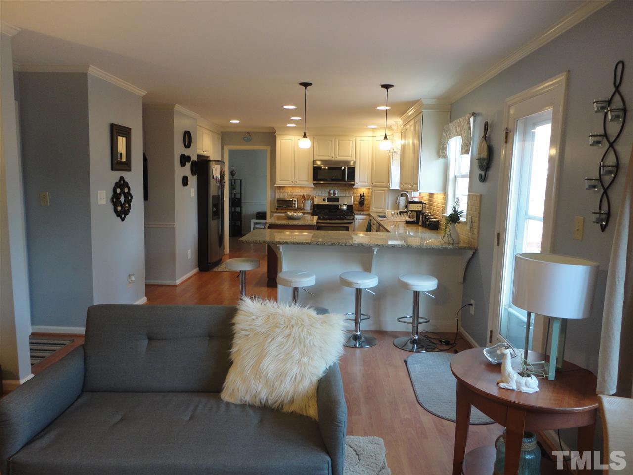 2369 Declaration Drive Raleigh, NC 27615 - Photo 9 of 20 a living room with furniture and a dining table with kitchen view