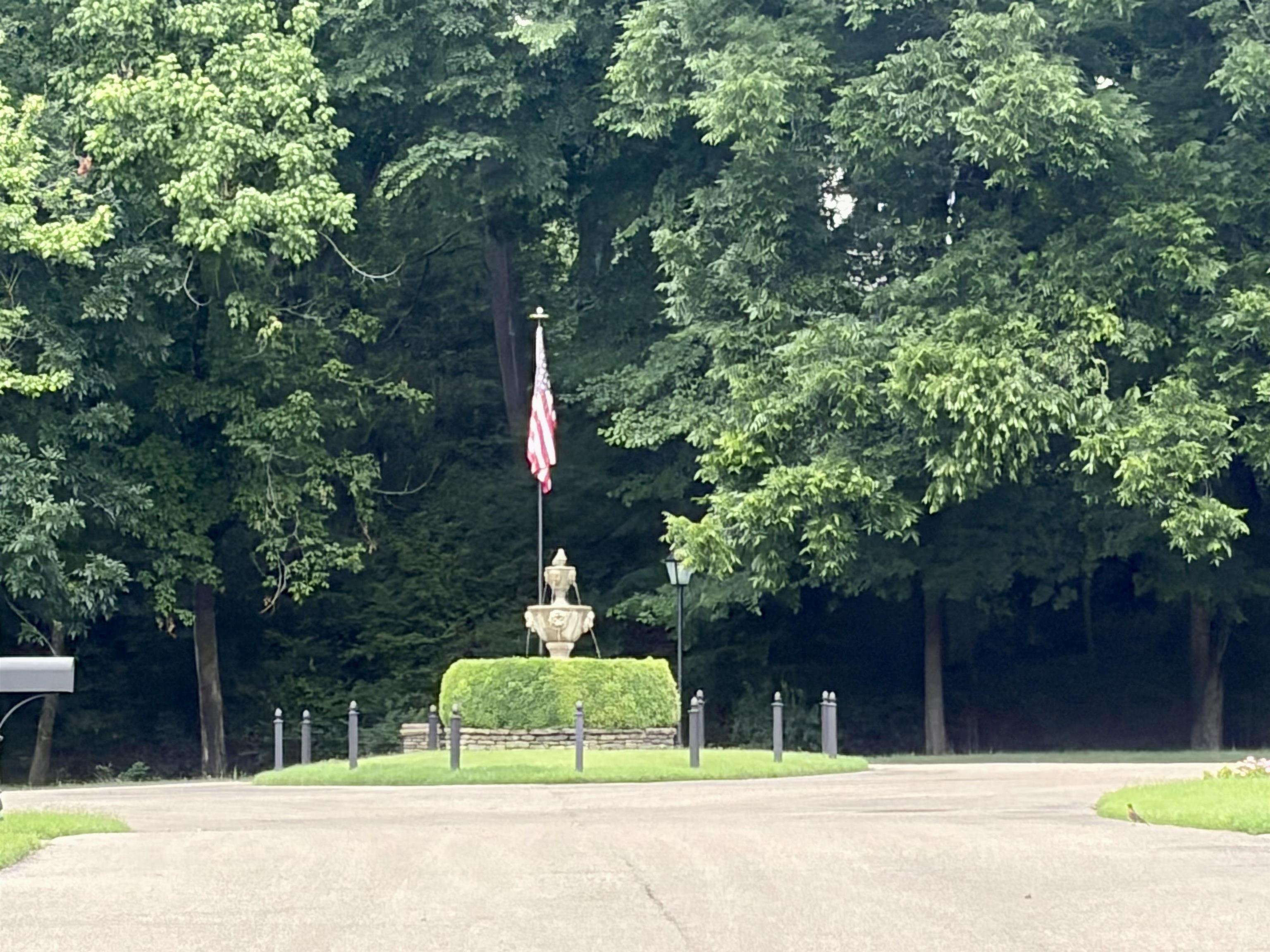 328 Washington Street Collierville, TN 38017 - Photo 33 of 33 Circular drive featuring a central fountain, manicured hedges, and mature trees