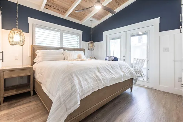 a large bed sitting in a bedroom next to a window