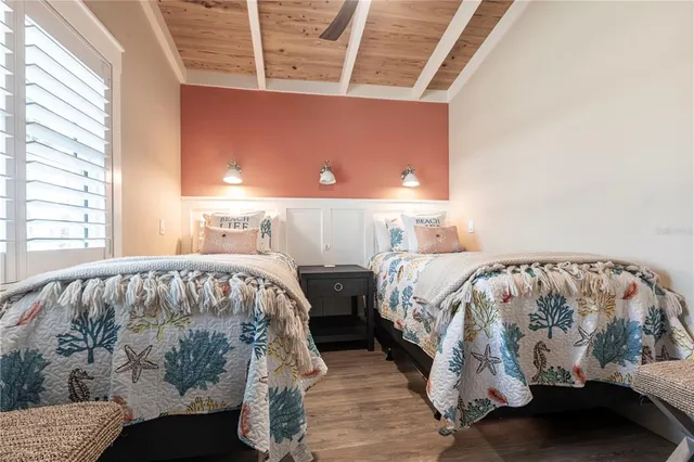 a bed sitting in a bedroom next to a window