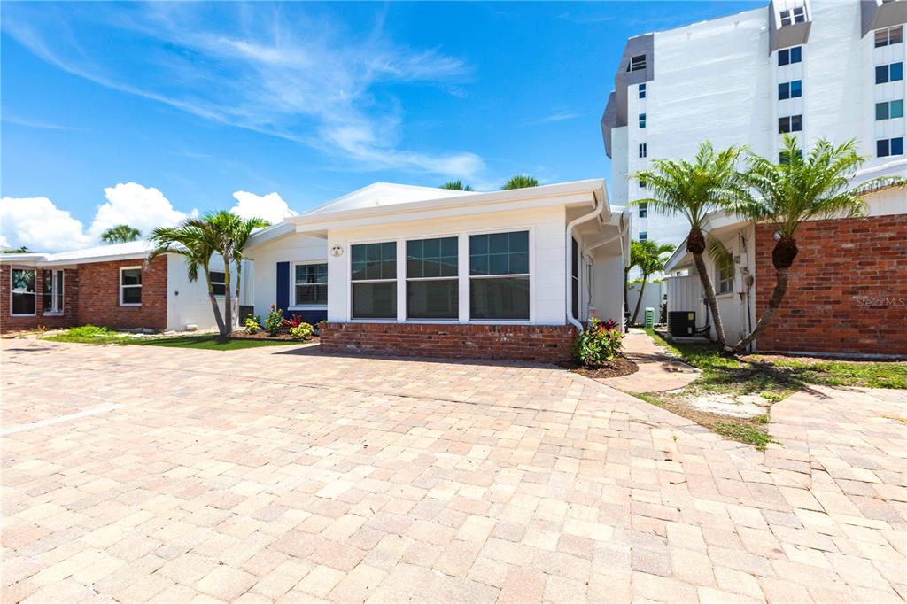 6020 Midnight Pass Road, Unit 39 Sarasota, FL 34242 - Photo 17 of 19 a front view of a house with a yard