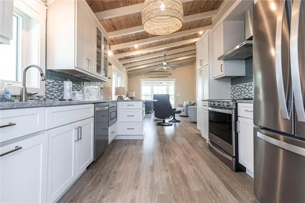 a kitchen with stainless steel appliances a stove top oven and cabinets