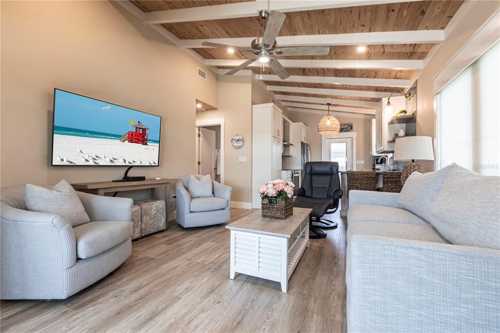 6020 Midnight Pass Road, Unit 39 Sarasota, FL 34242 - Photo 3 of 19 a living room with furniture and a flat screen tv
