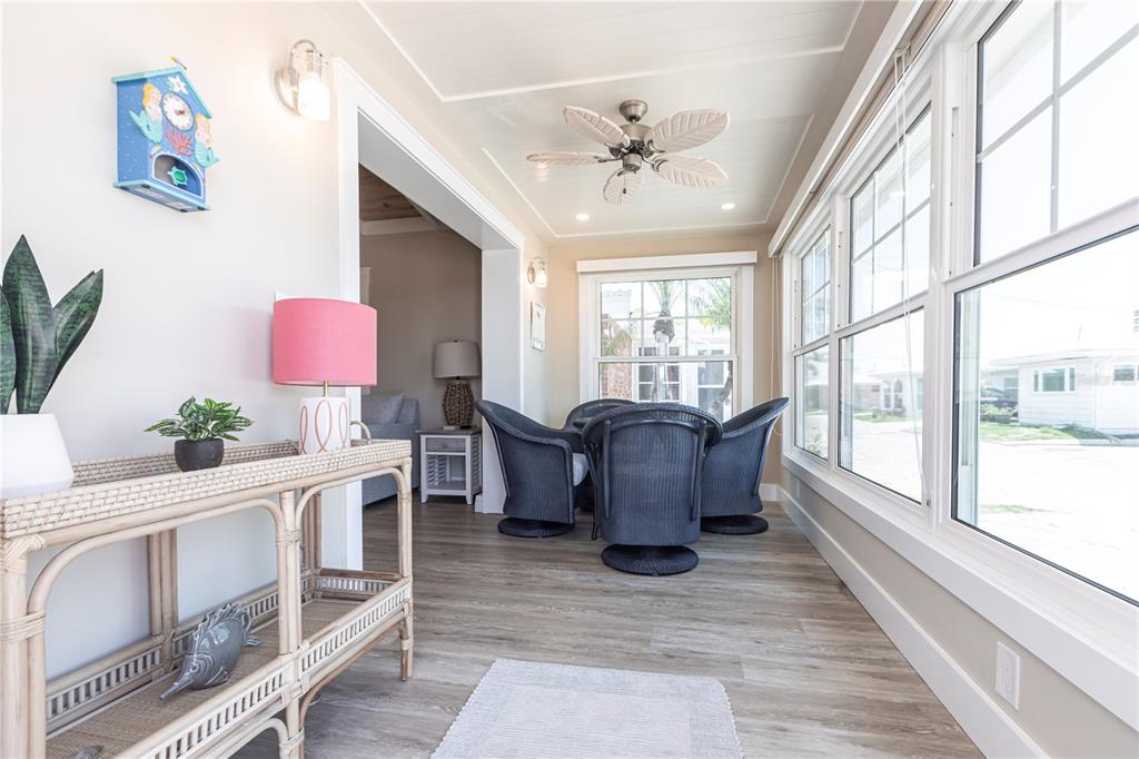 6020 Midnight Pass Road, Unit 39 Sarasota, FL 34242 - Photo 6 of 19 a living room with furniture large window and wooden floor