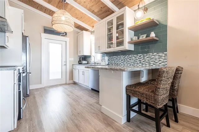 a kitchen view with table and chairs