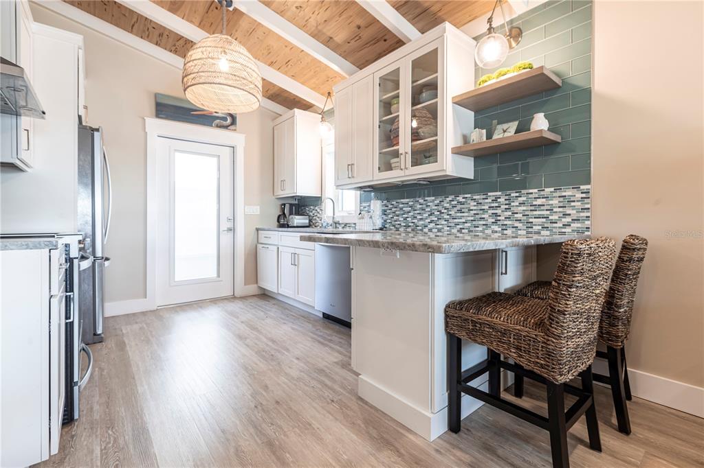 6020 Midnight Pass Road, Unit 39 Sarasota, FL 34242 - Photo 7 of 19 a kitchen view with table and chairs