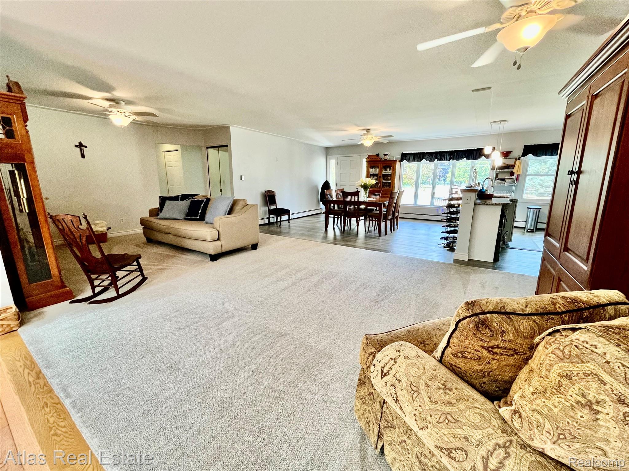 12026 Coolidge Road Goodrich, MI 48438 - Photo 29 of 56 Expansive open-concept living area with light-toned carpeting and wood-finish flooring