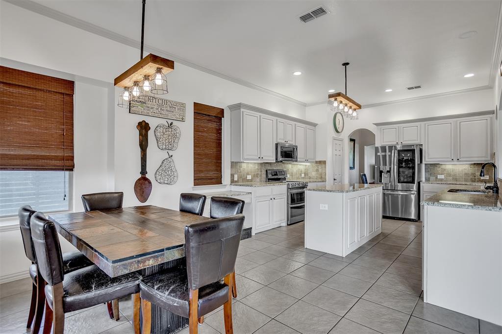 12286 Emerald Ranch Lane North Forney, TX 75126 - Photo 14 of 40 a view of kitchen with refrigerator dining table and chairs