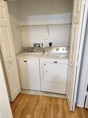 a view of washer and dryer with wooden floor