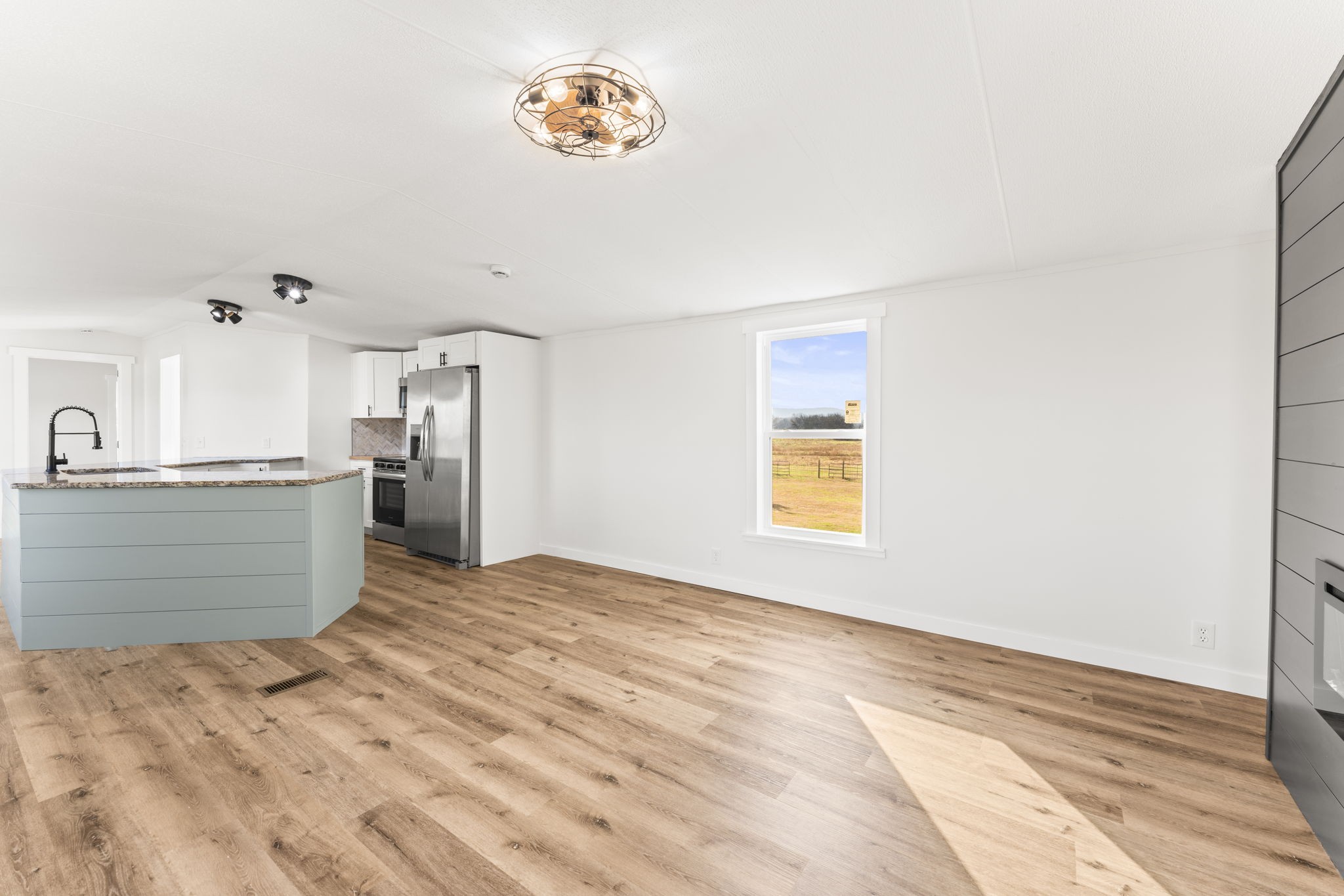 769 Stewart Road Huntland, TN 37345 - Photo 12 of 52 a view of kitchen and empty room with wooden floor