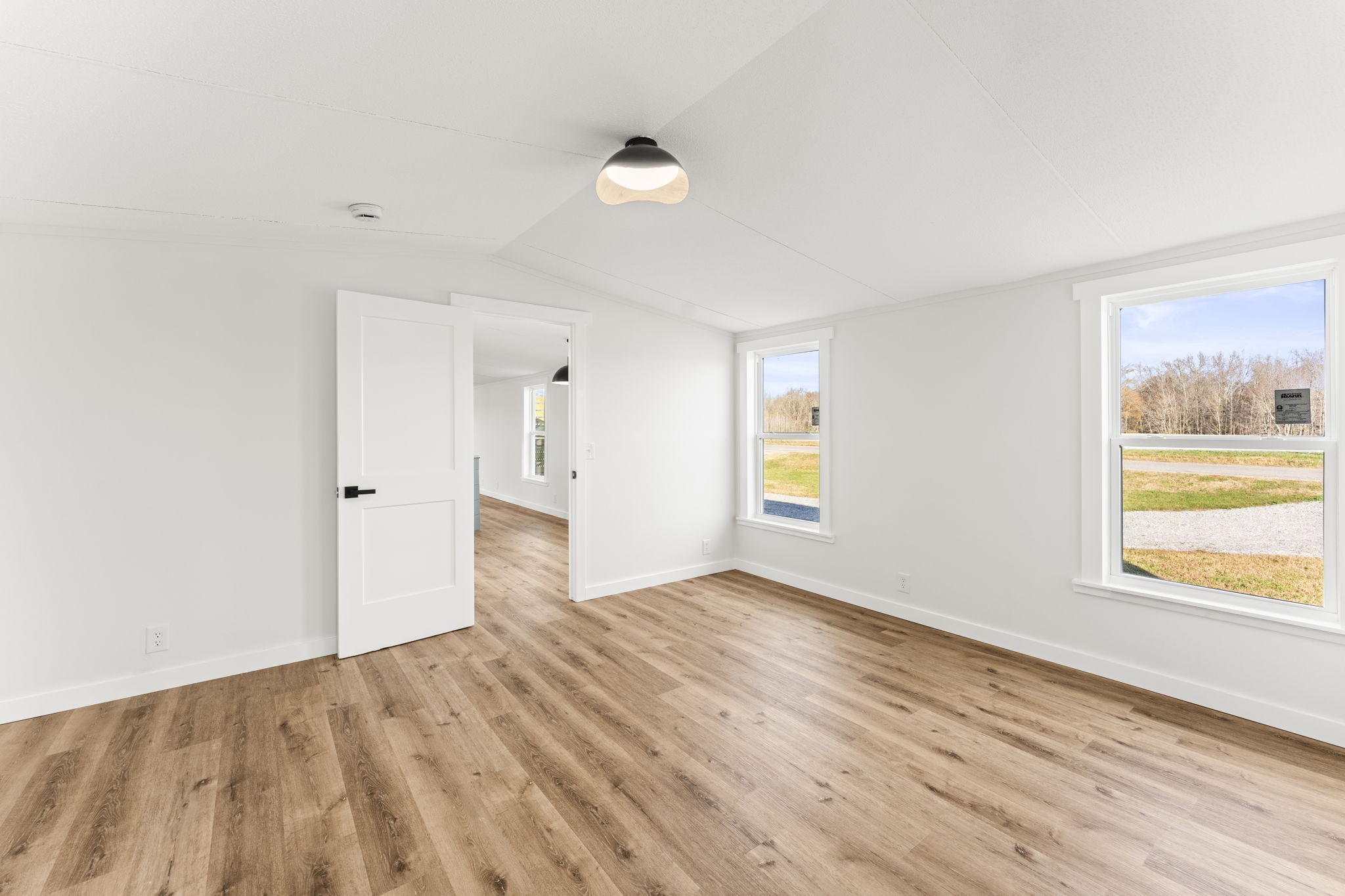 769 Stewart Road Huntland, TN 37345 - Photo 15 of 52 an empty room with wooden floor and windows