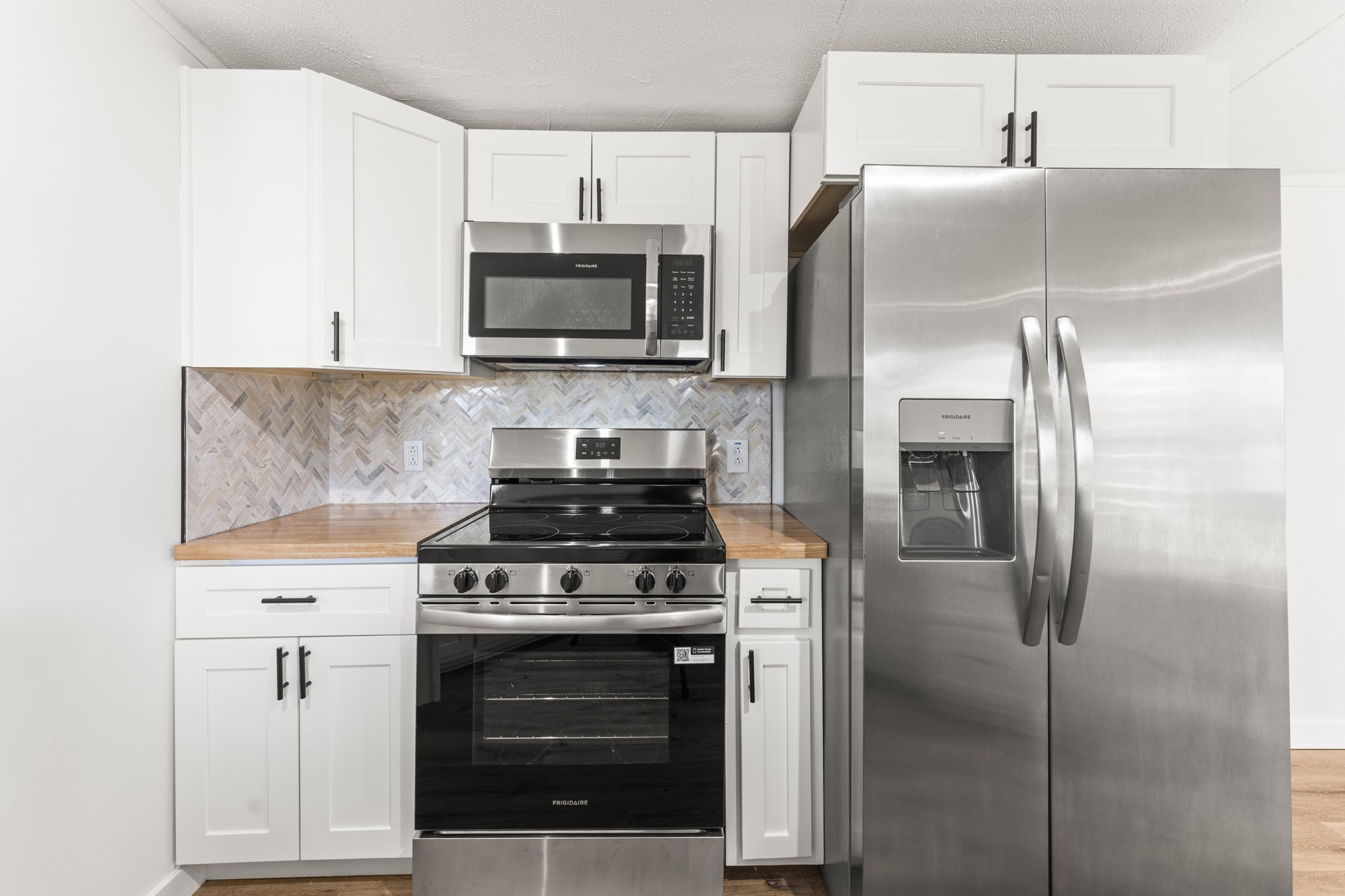 769 Stewart Road Huntland, TN 37345 - Photo 8 of 52 a kitchen with stainless steel appliances and white cabinets