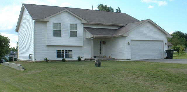 102 Rochester Road Northeast Poplar Grove, IL 61065 - Photo 1 of 1 a front view of house with yard