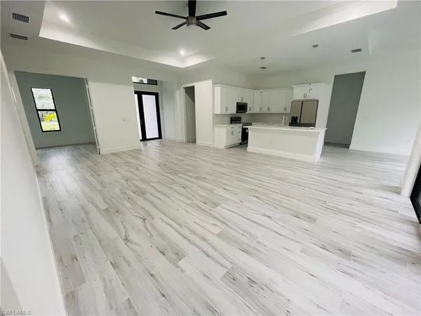 a view of a livingroom with a furniture hardwood floor and a ceiling fan
