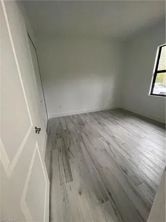 a view of a room with wooden floor and windows