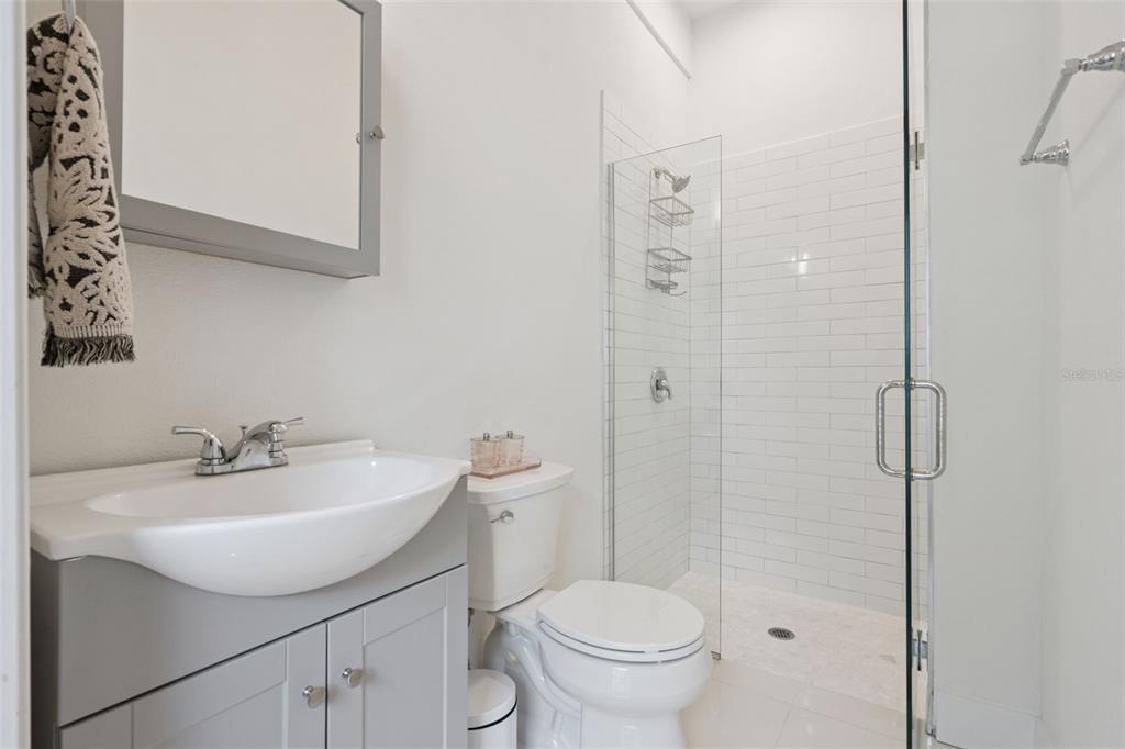 908 Croton Road Celebration, FL 34747 - Photo 50 of 86 a bathroom with a sink a toilet and shower