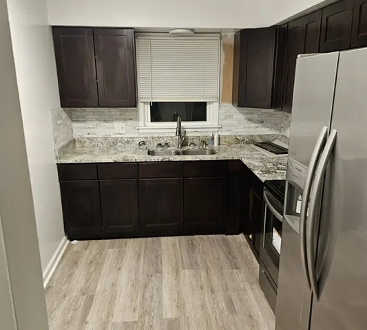 a kitchen with stainless steel appliances a sink and cabinets