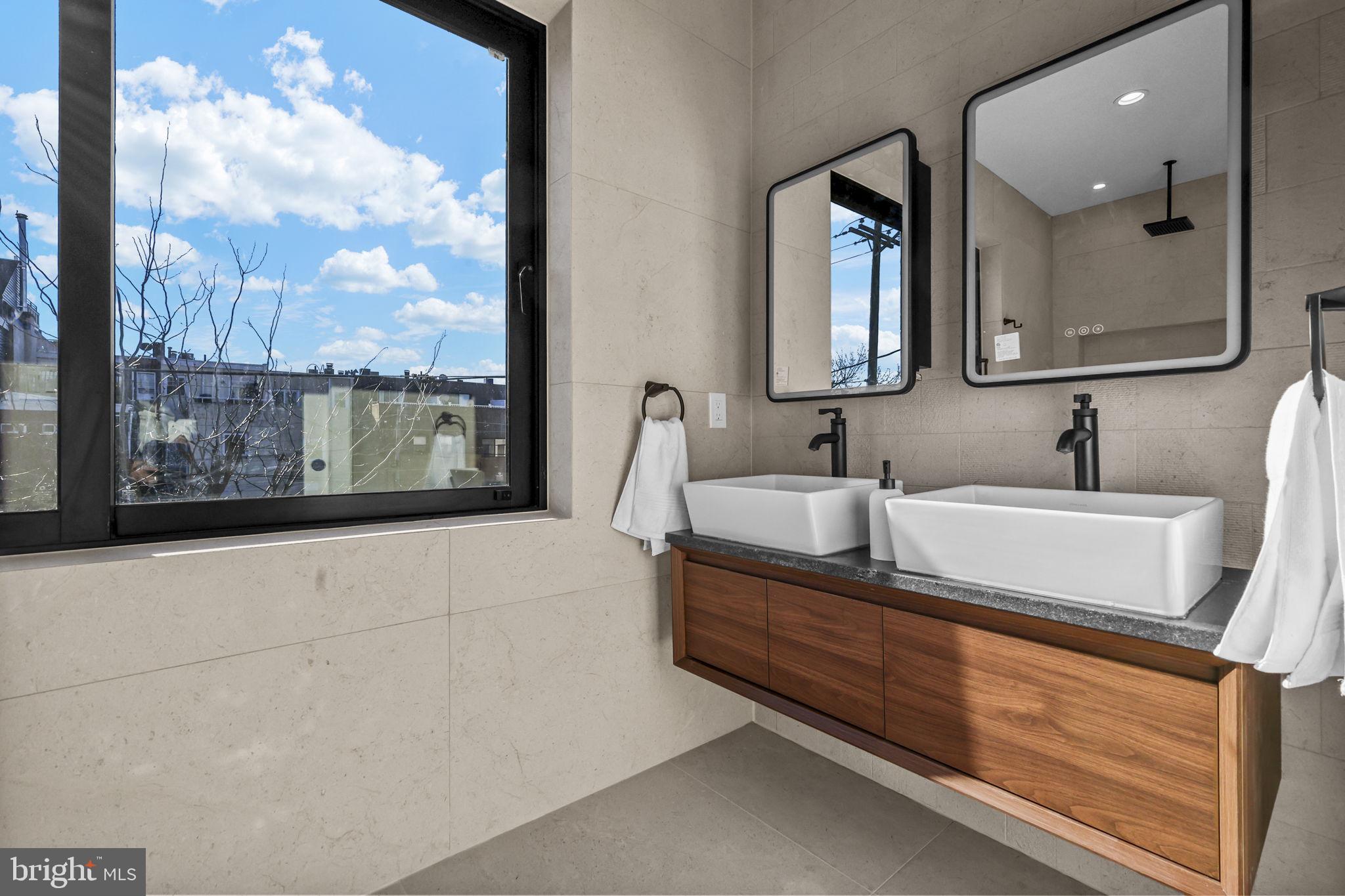 514 South 20th Street, Unit B Philadelphia, PA 19146 - Photo 21 of 52 a bathroom with a double vanity sink and a mirror
