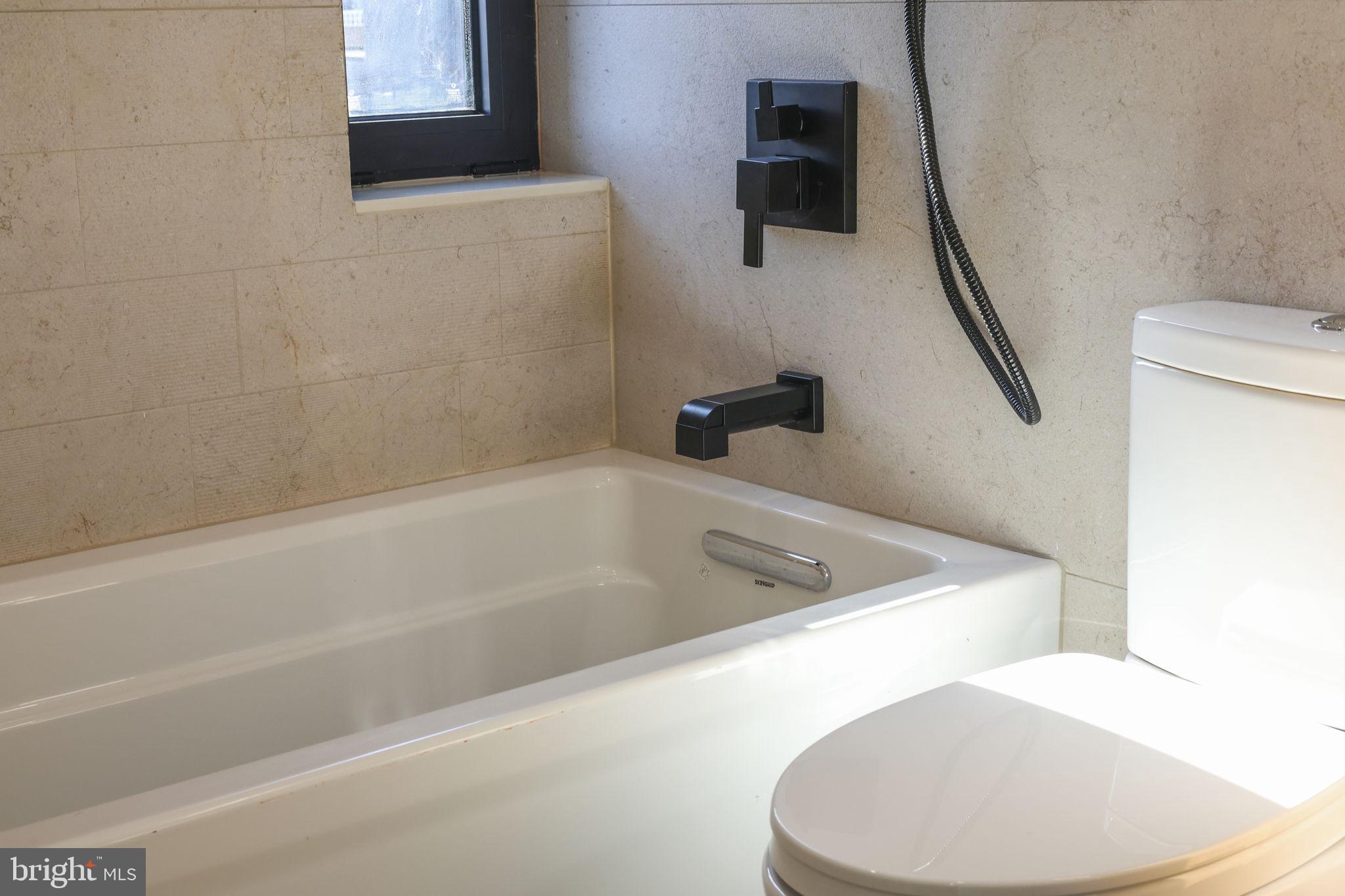 514 South 20th Street, Unit B Philadelphia, PA 19146 - Photo 27 of 52 a bath tub sitting next to a white toilet and sink