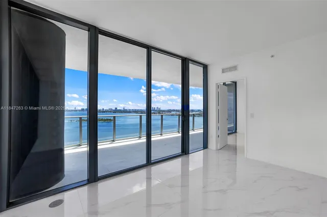 a view of a back yard of the house and a large tree