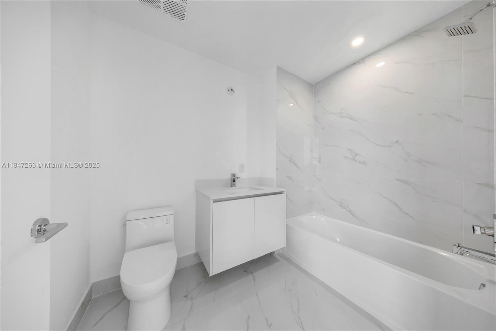 700 Northeast 24th Street, Unit 2101 Miami, FL 33137 - Photo 63 of 100 a bathroom with a sink a toilet and shower