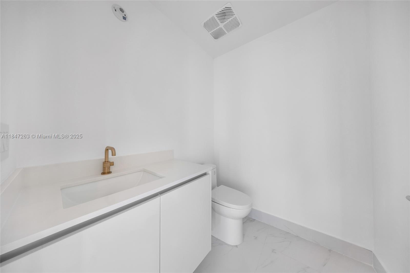 700 Northeast 24th Street, Unit 2101 Miami, FL 33137 - Photo 70 of 100 a bathroom with a sink a toilet and mirror