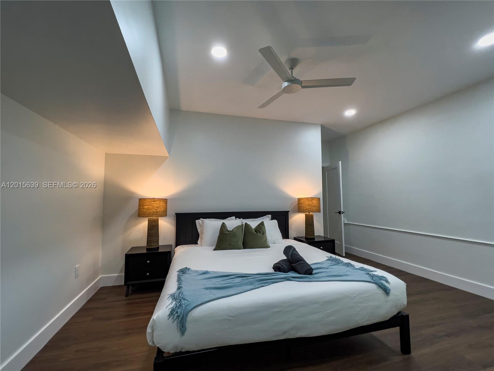 545 Southwest Indianola Street Stuart, FL 34994 - Photo 43 of 64 a bedroom with a bed and a night stand