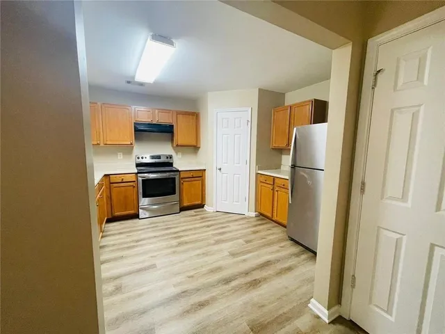 a kitchen with a refrigerator a stove and a microwave
