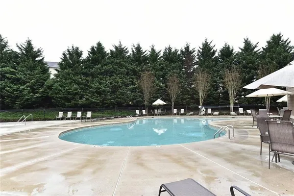 a view of a swimming pool and lounge chairs